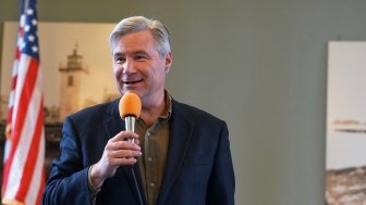 Sen. Sheldon Whitehouse speaks into a microphone